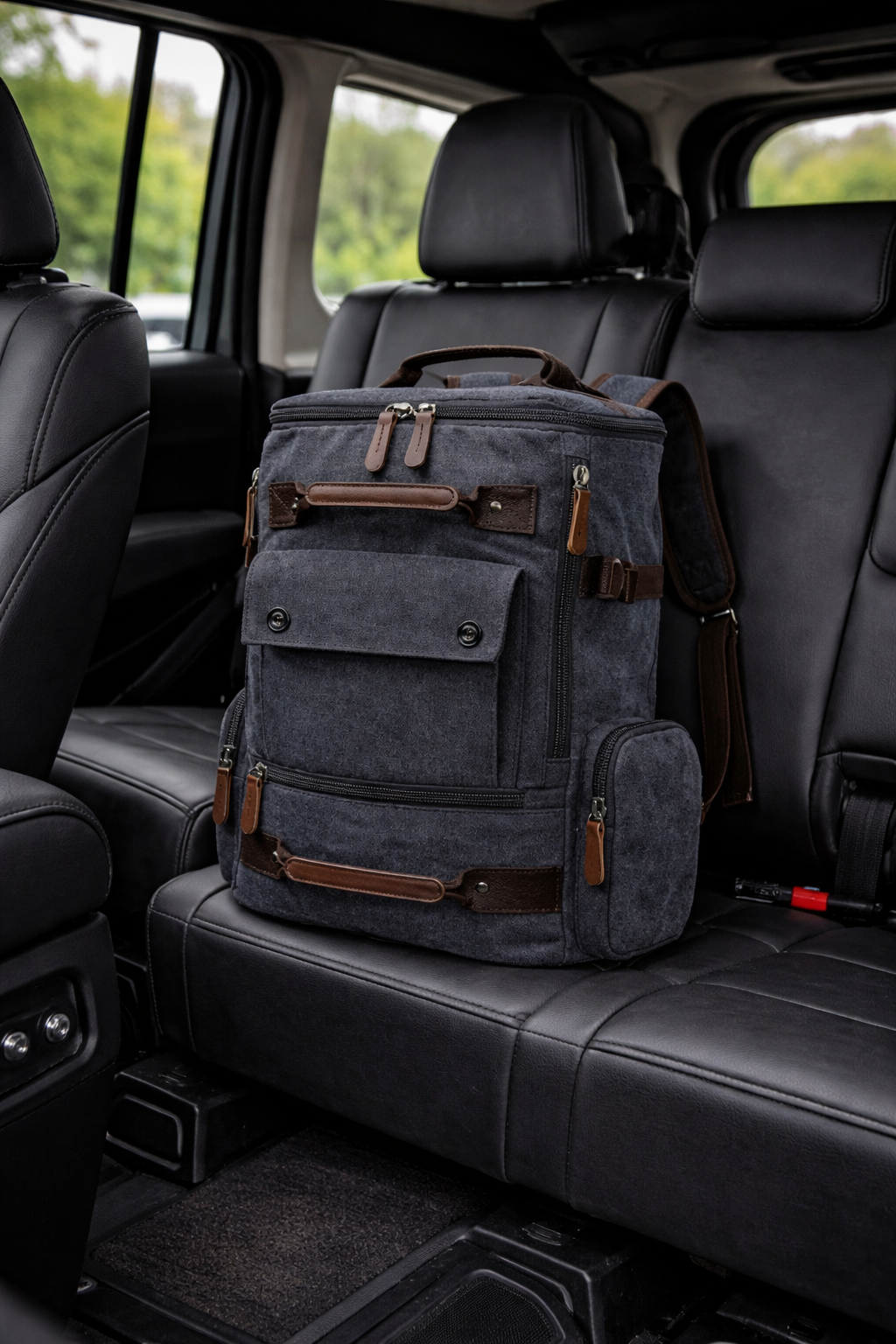 Gray backpack with brown accents on a car seat