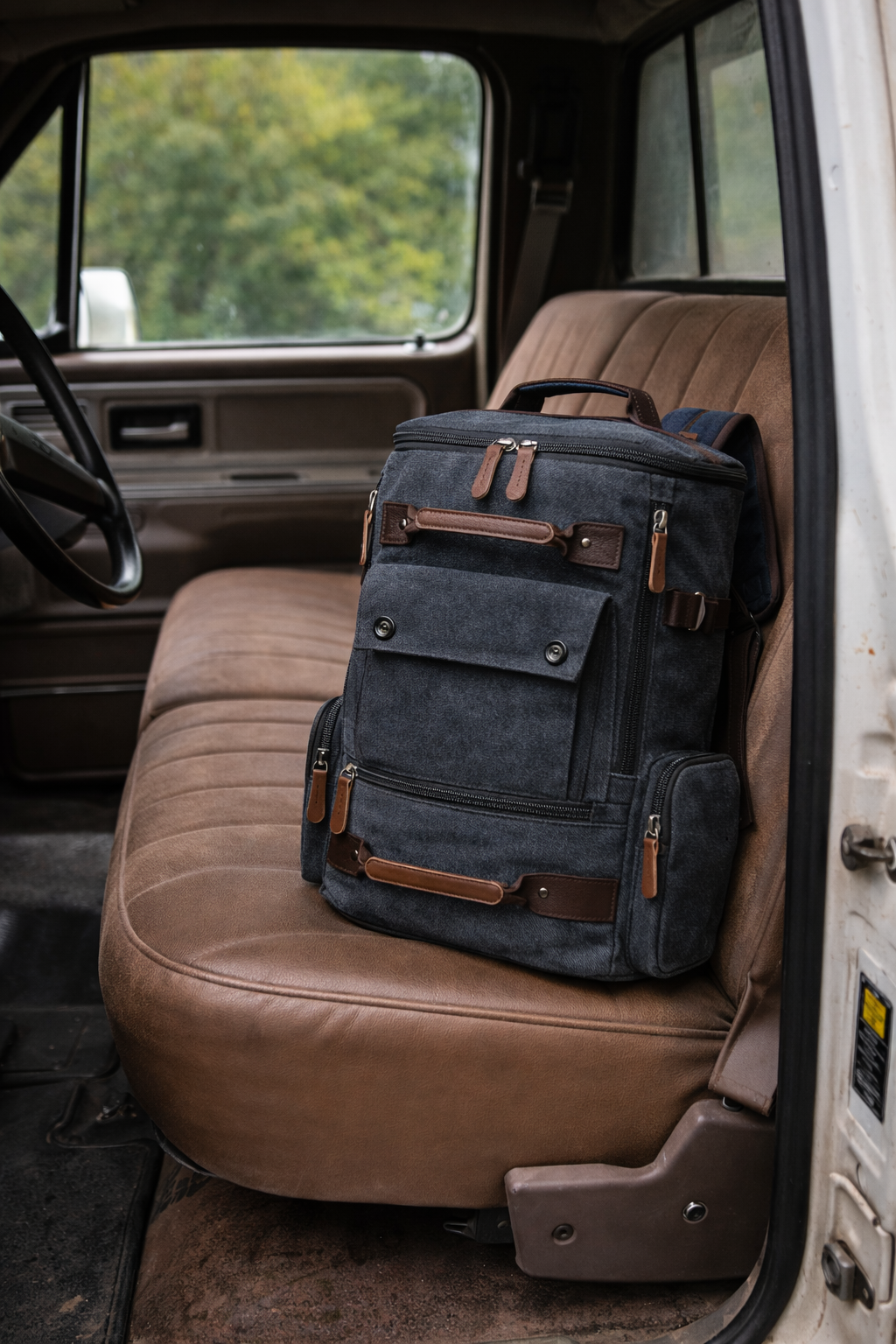 Blue backpack with brown accents on a brown car seat
