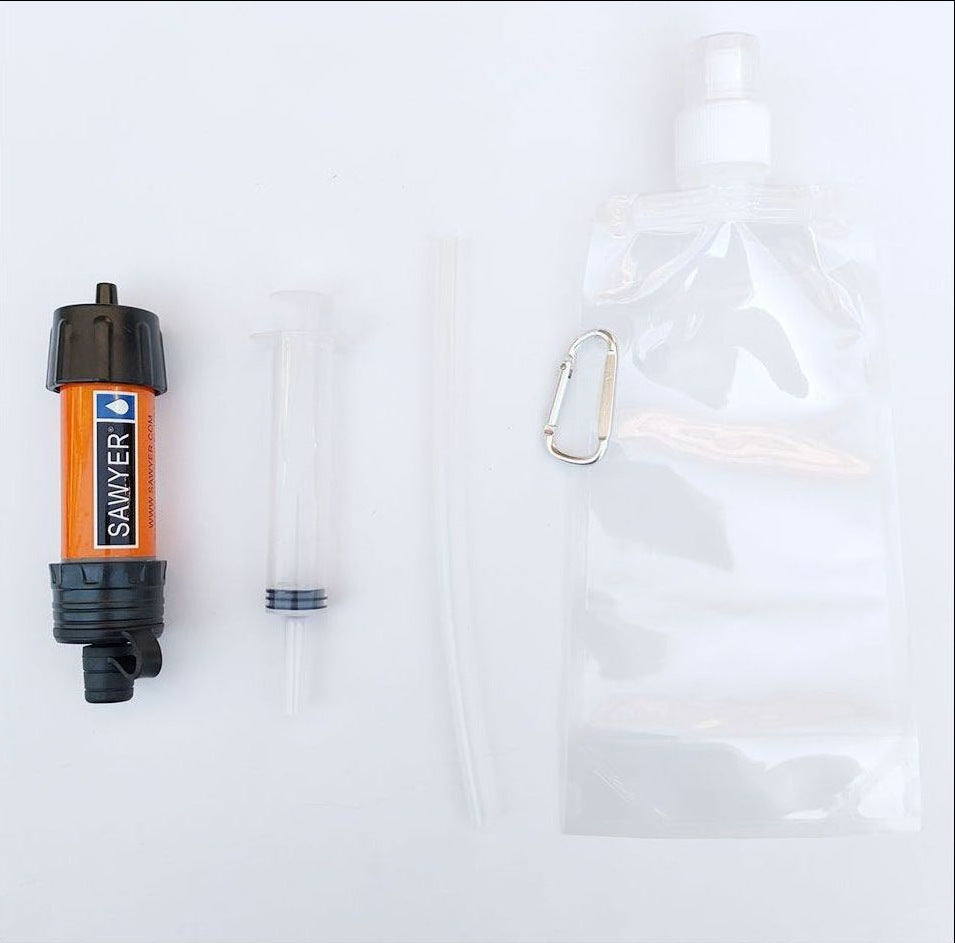 Sawyer water filter with a carabiner and clear bag on a white background