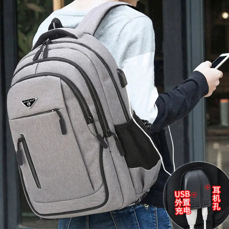 Person wearing a gray backpack with USB charging port feature highlighted